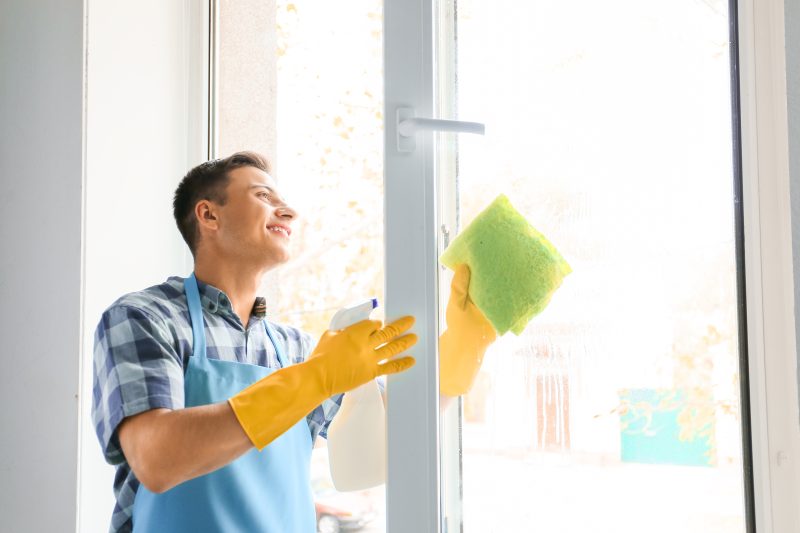 how to clean windows - man cleaning window